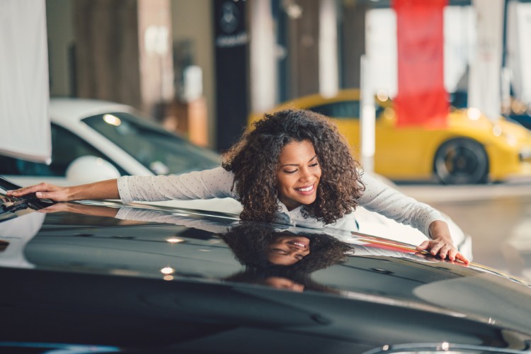 woman hugging car